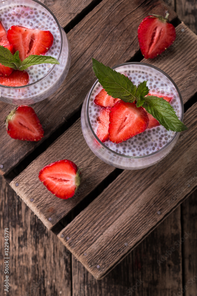 chia seed pudding with strawberries and min on wooden vintage background chia seed pudding with strawberries and min on wooden vintage background