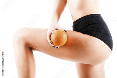 cellulite - orange skin effect in women's thighs, isolated on ba