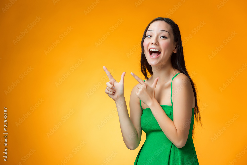 The happy Chinese girl on yellow background The happy Chinese girl on yellow background