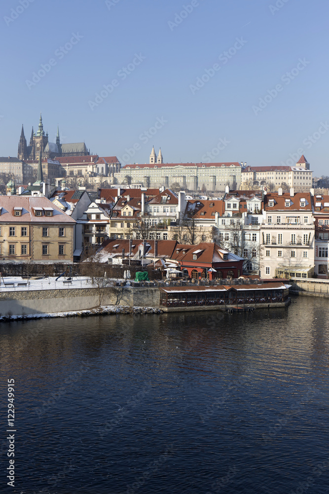 Snowy Prague gothic Castle above river Vltava in the sunny Day,  Czech Republic