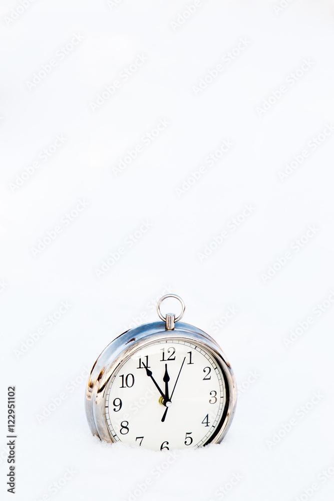 Metallic old clock in snow close up. Metallic old clock in snow close up.