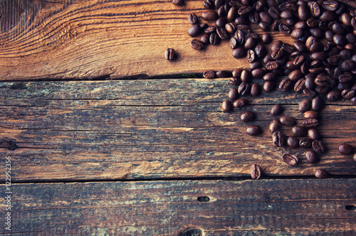Coffee beans on vintage wooden background. Copyspace