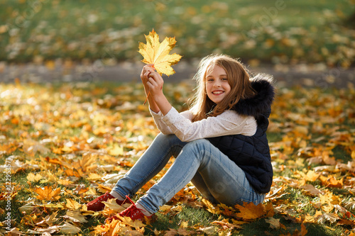 Cute Teenager girl walks in Autumn park. Sunny day  selective focus