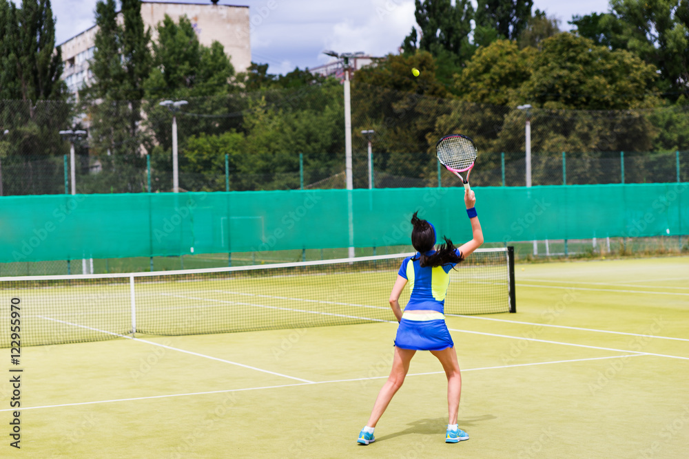 Woman tennis player in action on a court outdoor