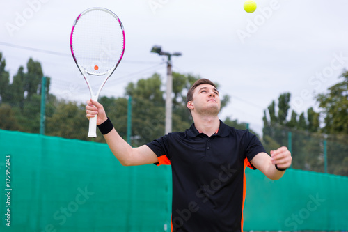 Male tennis player in action during a match © kolotype