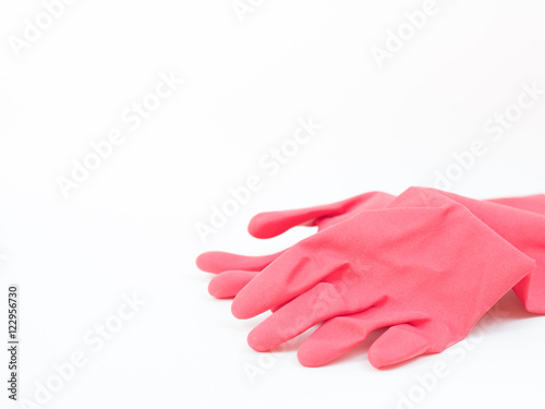 red rubber gloves on white background © angyim