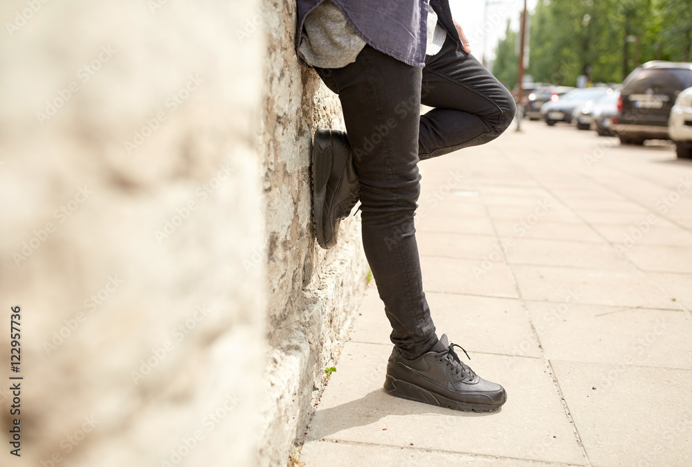 close up of man standing at street wall close up of man standing at street wall