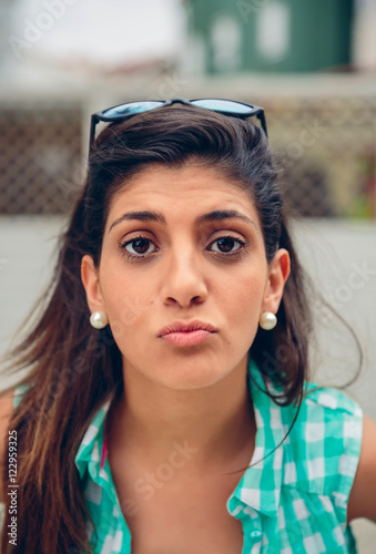 Happy woman blowing kiss at camera outdoors