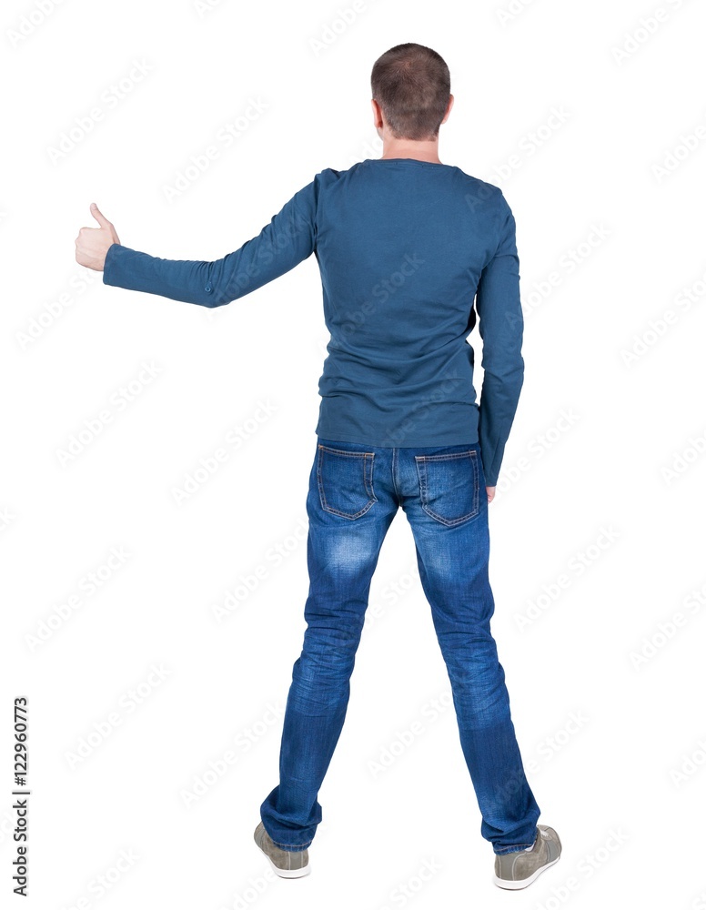 Back view of man in t-shirt. shows thumbs up. Rear view people collection. backside view of person. Isolated over white background. Back view of man in t-shirt. shows thumbs up. Rear view people collection. backside view of person. Isolated over white background.