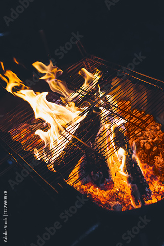 Grill at night, fireflames and hot coals photo