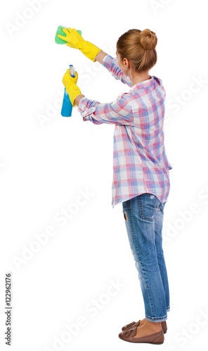 Back view of a housewife in gloves with sponge and detergent. girl watching. Rear view people collection. backside view of person. Isolated over white background.