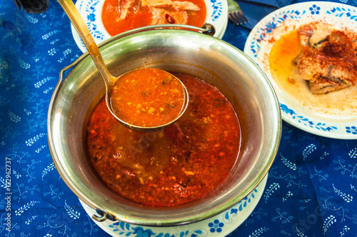 Traditional hungarian fish soup in Bogrács photo