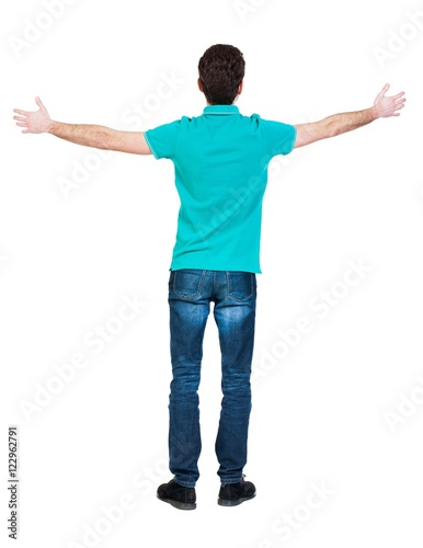 A man raised his hands in prayer.   Standing young man. Rear view people collection.  backside view of person.  Isolated over white background. A guy in a T-shirt is stylish aquamarine arms to the