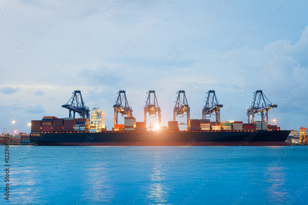 Logistics and transportation of International Container Cargo ship with ports crane bridge in harbor for logistic import export background and transport industry...