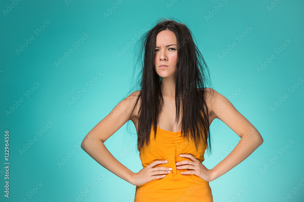 Frustrated young woman having a bad hair Frustrated young woman having a bad hair