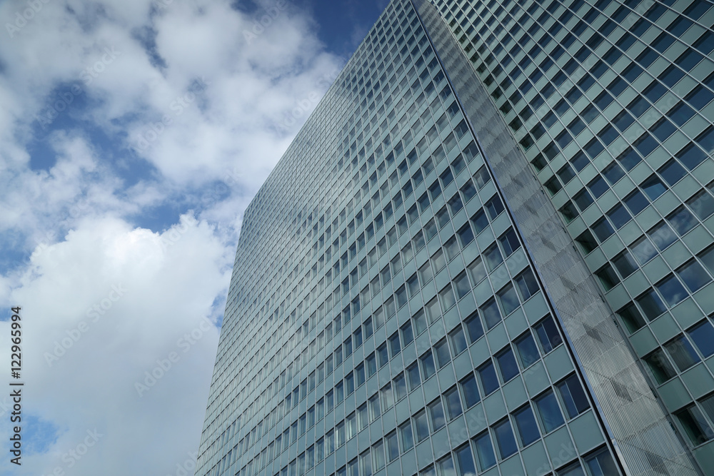 clouds reflected in the windows of high-rise building