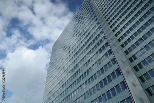clouds reflected in the windows of high-rise building
