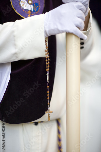 Penitent bearing a candle and a rosary, Holy Week, Seville, Spain