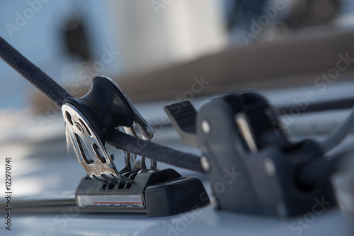 Detail of pulley, fairlead of a sport sailboat. Nautical equipment. photo