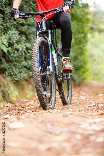 Male cyclist cycling in countryside