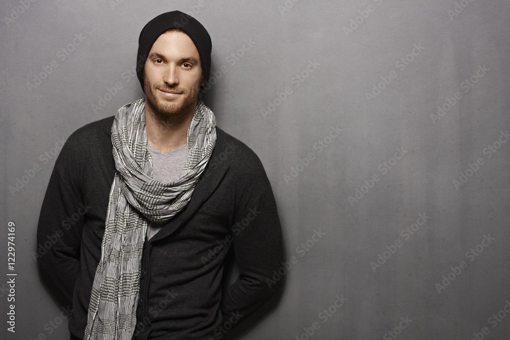 Casual young man smiling over grey wall Casual young man smiling over grey wall