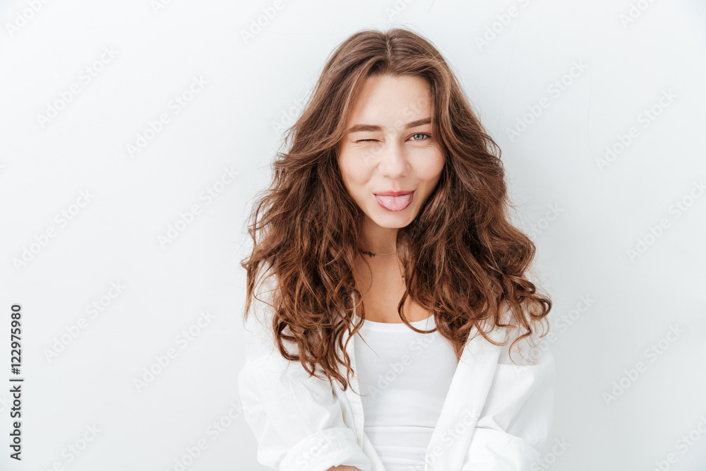 Portrait of cute playful young woman showing tongue Portrait of cute playful young woman showing tongue