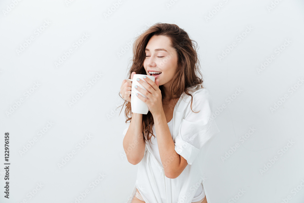 Happy attractive woman with eyes closed drinking cup of tea Happy attractive woman with eyes closed drinking cup of tea