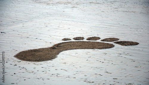 Painted footprint in the sand. Saint-Malo, Brittany, France