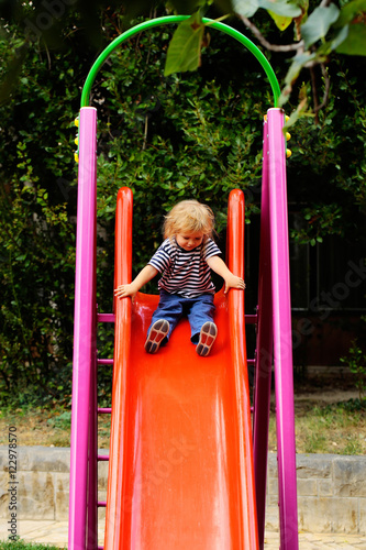 Cute baby boy on slide