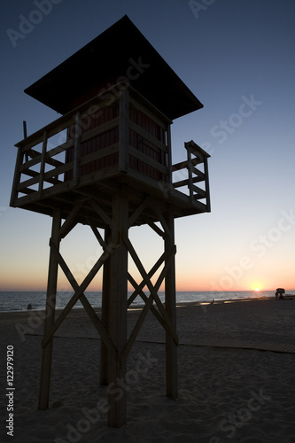 Lifeguard tower at sunset, Matalascañas beach, Huelva, Spain photo