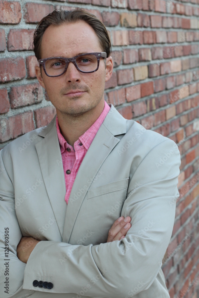 Young handsome businessman with glasses against the brick wall Young handsome businessman with glasses against the brick wall