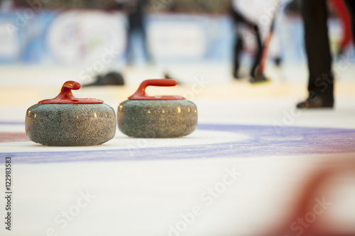 Fototapete Curling stones on ice