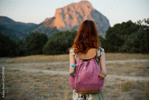 A young woman traveling in the summer in the mountains 