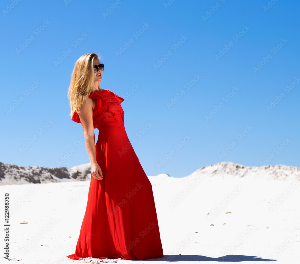 Women in a red dress in the desert Women in a red dress in the desert
