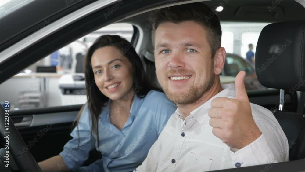 Man shows his thumb up inside the car Man shows his thumb up inside the car