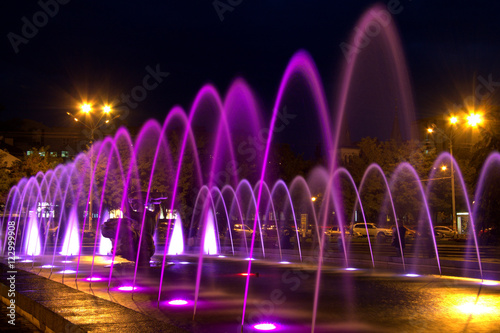 Beautiful multi-colored fountain near the Opera House in the city Dnepr at night (Dnepropetrovsk), Ukraine.