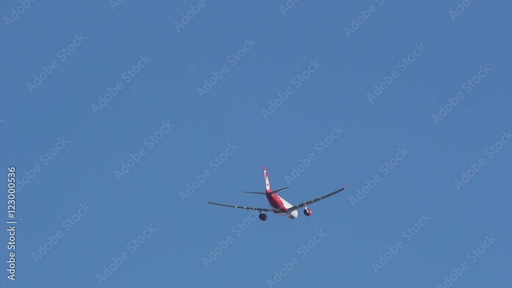 Commercial airliner flying overhead on sunny day with jet contrails lining the blue sky. Commercial airliner flying overhead on sunny day with jet contrails lining the blue sky.