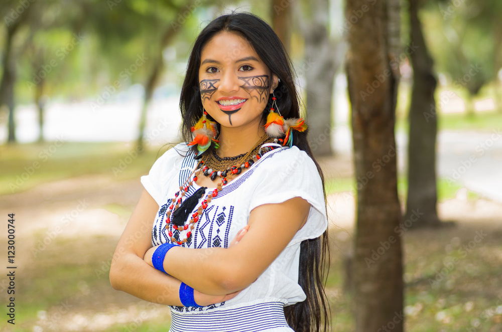Beautiful Amazonian woman with indigenous facial paint and white