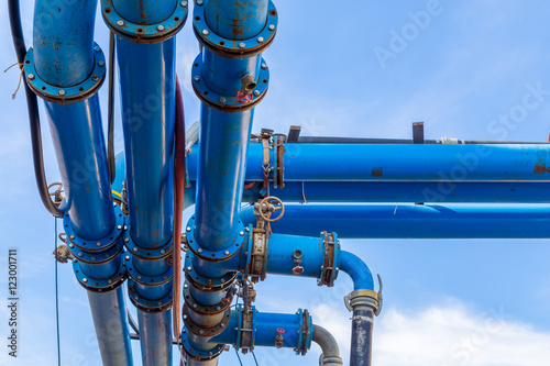 Isolated blue outdoor pipelines with valves.