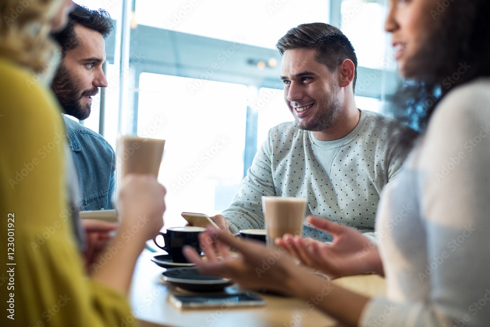 Smiling friends having a cup of coffee Smiling friends having a cup of coffee