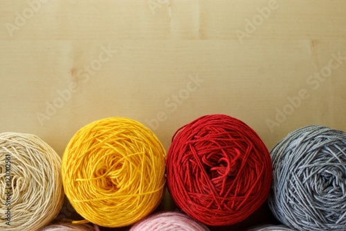 Balls of wool cotton silk yarn set on copy space wood background on top