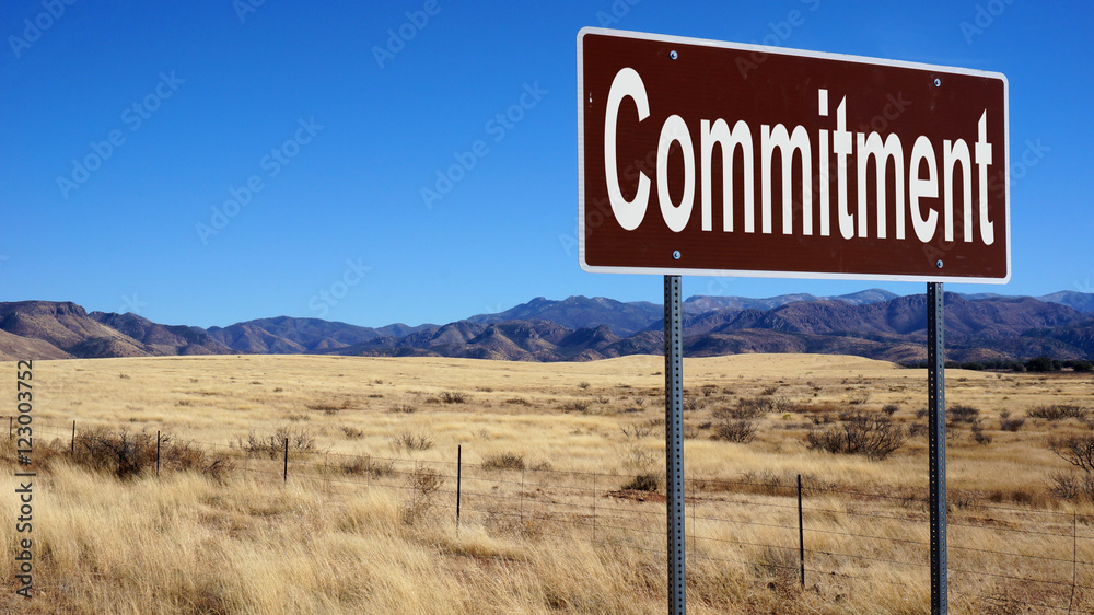 Commitment brown road sign