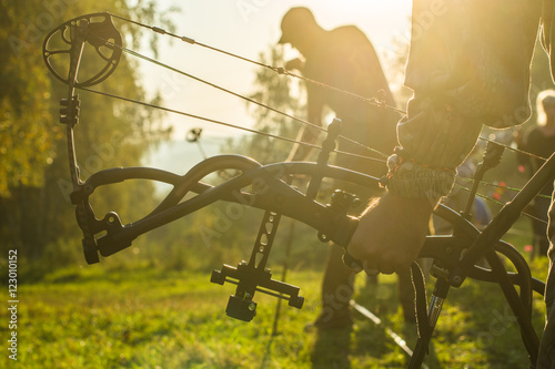 Archers silhouettes on forest background
