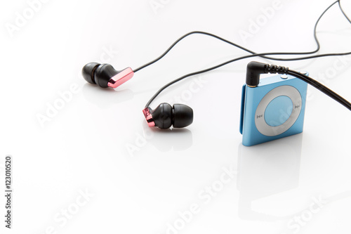 Earbuds and an mp3 player on a white background