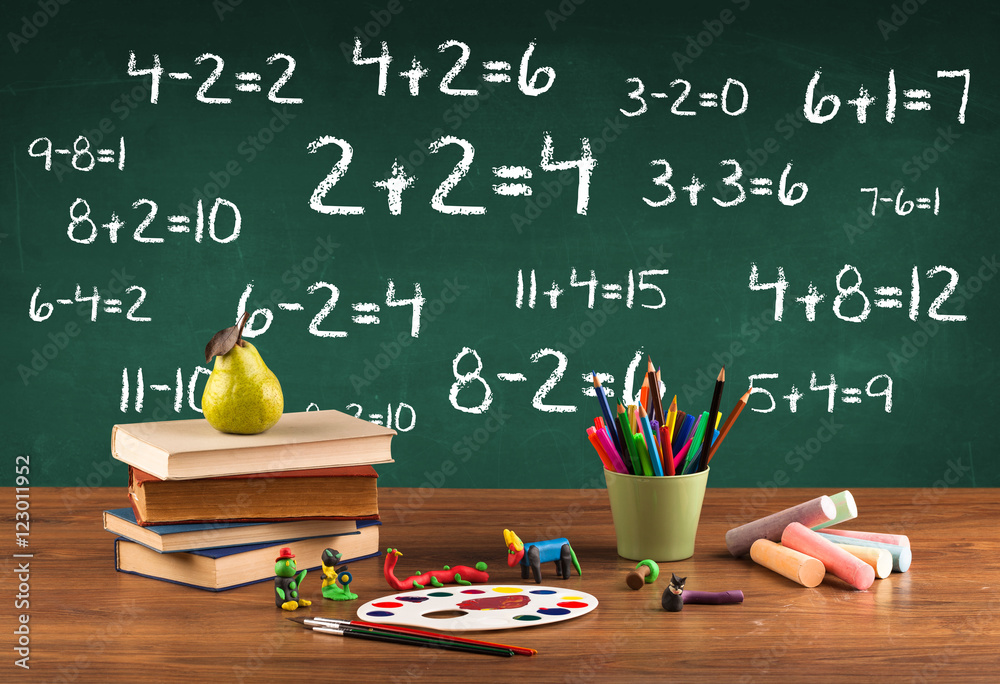 School blackboard with pile of books School blackboard with pile of books
