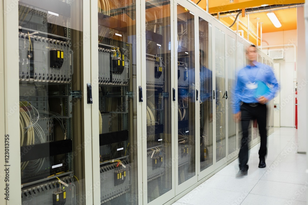 Fototapeta premium Technician walking in server room