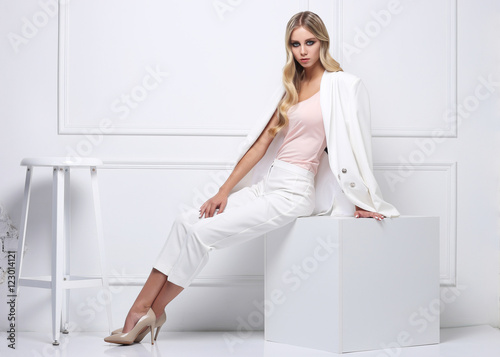 High fashion shot of young woman in white suit