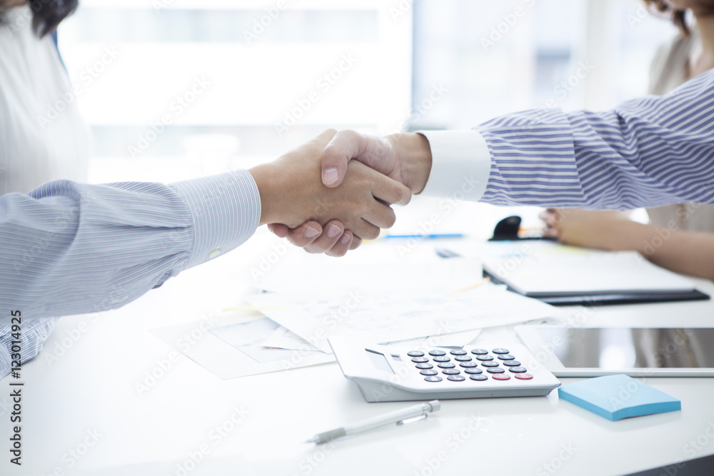 Businessmen and customers who are shaking hands in the company Businessmen and customers who are shaking hands in the company