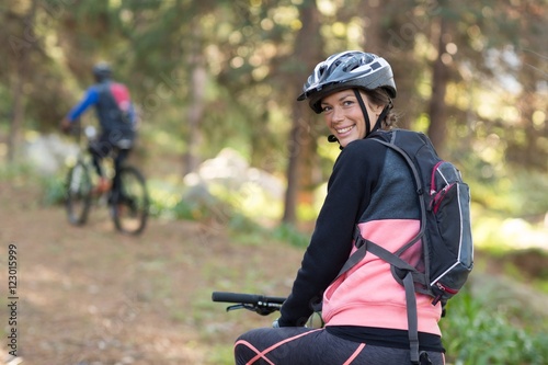 Female biker with mountain bike in countryside