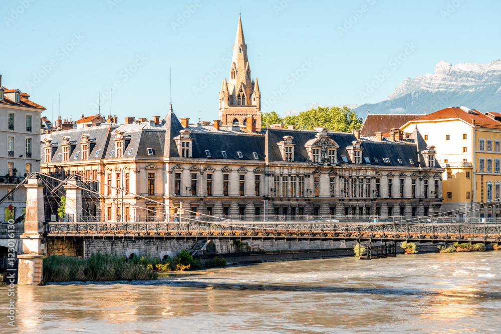 Fototapeta premium Morning cityscape view with mountains, river and bridge in Grenoble city on the south-east of France